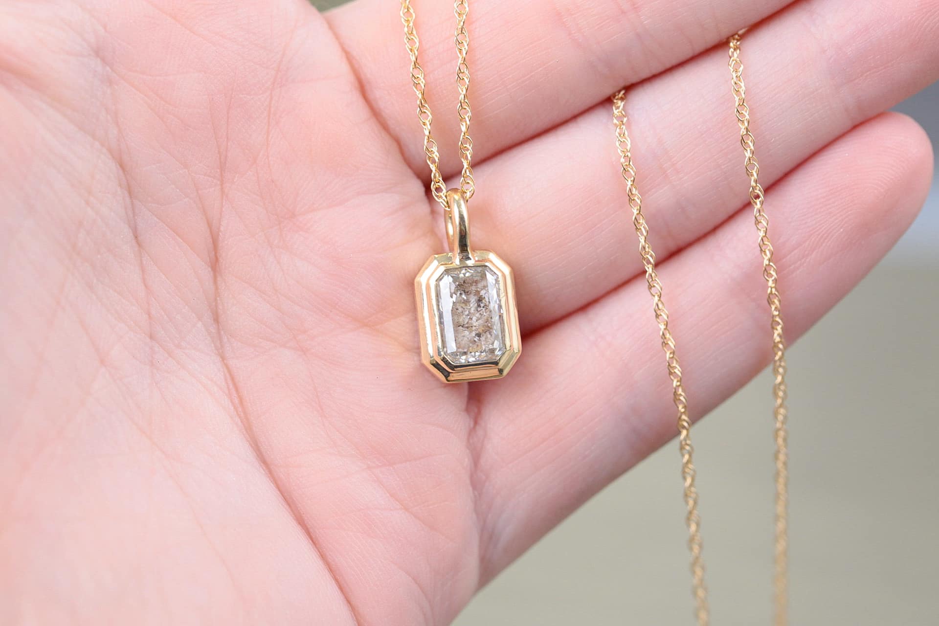 Sugarberry Memorials cremation pendant held in a hand
